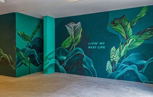 a large mural in a room with a wooden floor
