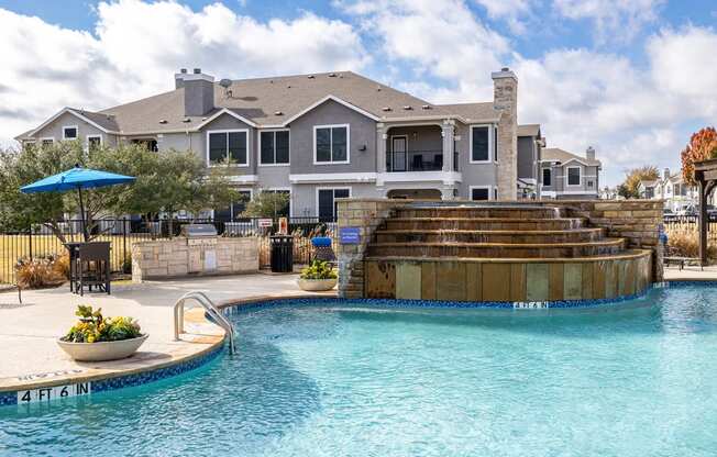 a swimming pool with a house in the background  at Orion Prosper Lakes, Prosper, Texas