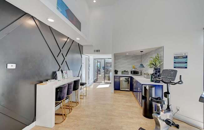 A gym with a treadmill, exercise bike, and weights.