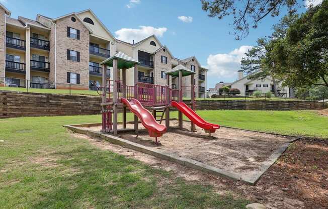 A red playground with slides at Gwinnett Square Apartments in Duluth, GA