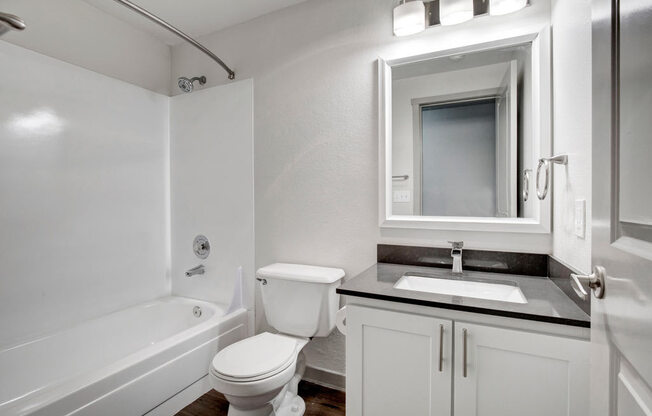 a bathroom with a toilet sink and bathtub