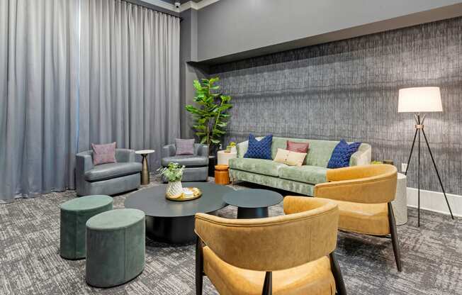 a living room with couches and chairs and a table at Madison on the Meadow, Stafford