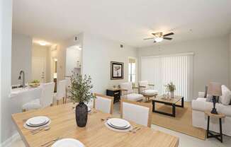 A dining room with a table set for four.