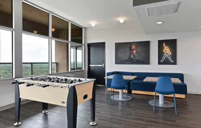 a game room with a foosball table and a blue couch