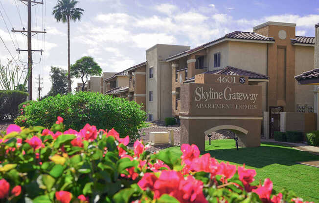 The image shows a beautiful view of the Skyline Gateway Apartment Homes entrance with a sign that reads "4601 Skyline Gateway Apartment Homes".
