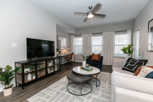an open living room with a couch and a tv at Willowest in Lindbergh, Georgia, 30318