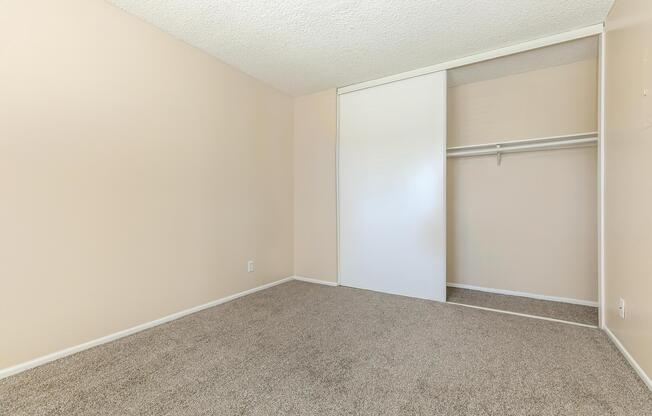 a bedroom with a bed and a mirror