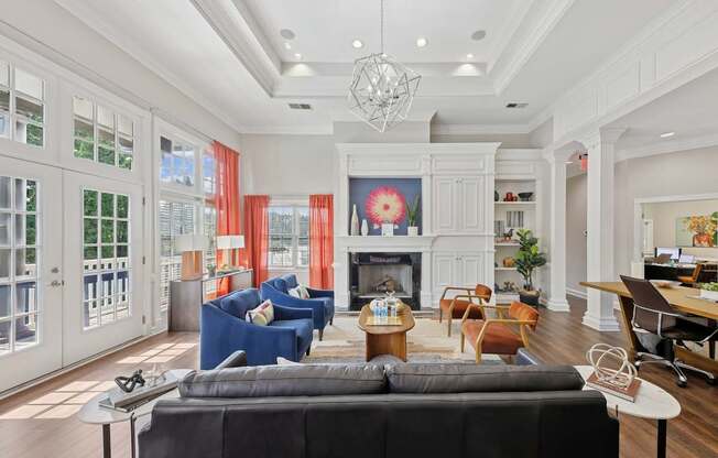 A living room with a black couch and a fireplace.
