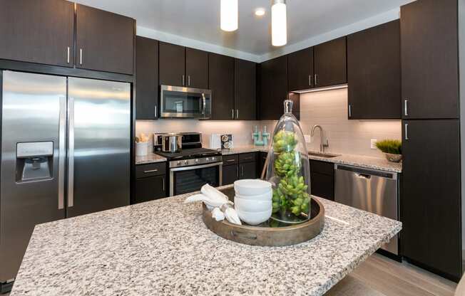 a kitchen with stainless steel appliances and granite counter tops