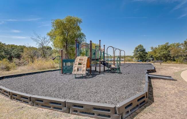 A playground in a park with a blue sky in the background