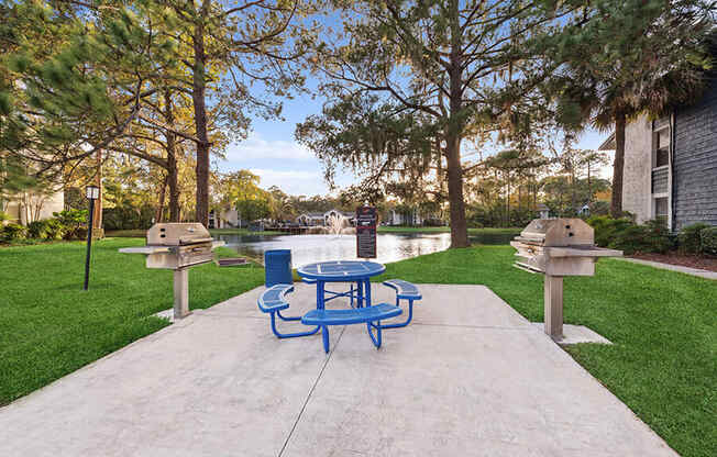 Outdoor BBQ Area with Furniture at Vue at Baymeadows Apartments in Jacksonville, FL.