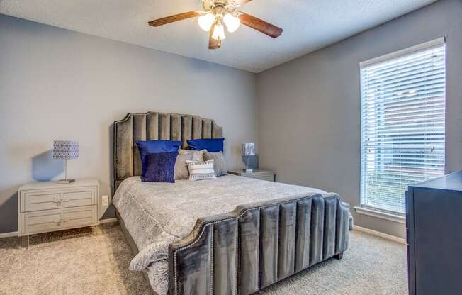 a bedroom with a bed and a ceiling fan