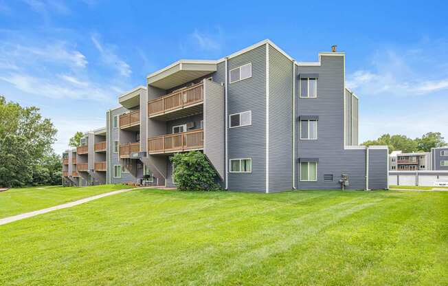 Apartment building with a green lawn in front.