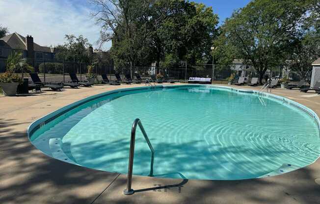 A rectangular pool with a metal ladder on the side.