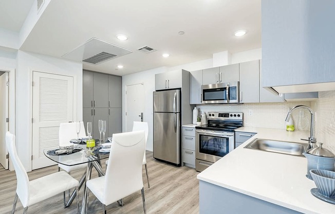 Kitchen with Built-in stainless-steel refrigerator, stove, microwave, and dishwasher, Quartz Countertops