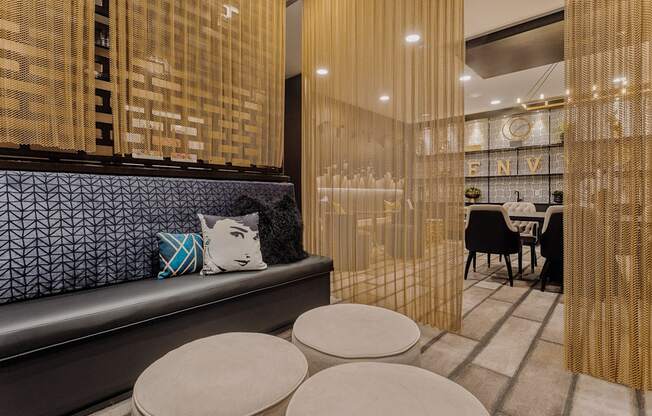 a seating area with a bench and four stools in a room with a table