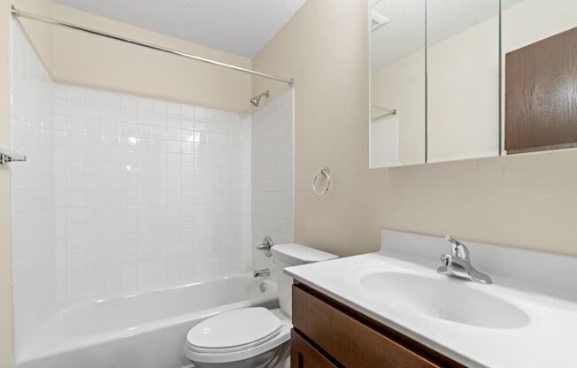 a bathroom with a sink toilet and bath tub