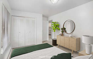 An upgraded bedroom with a green bedspread and a large closet at Wingate Apartments, Michigan
