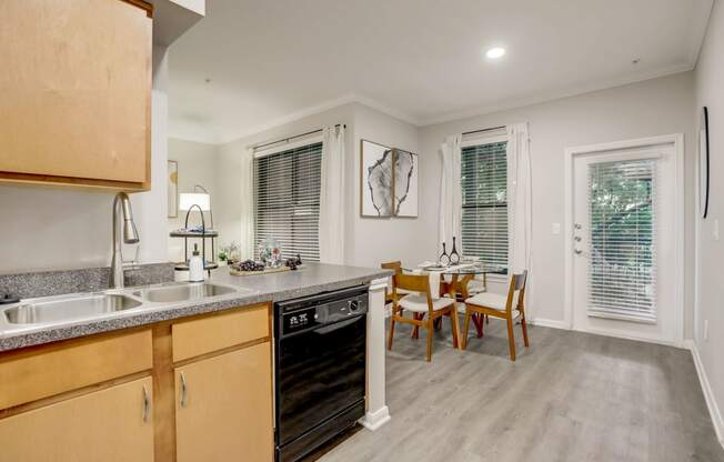 a kitchen and dining room with a table and chairs and a sink at The Vista on Brodie, Austin, TX