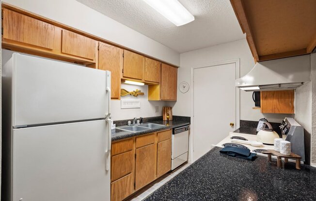 a kitchen with a refrigerator and a sink