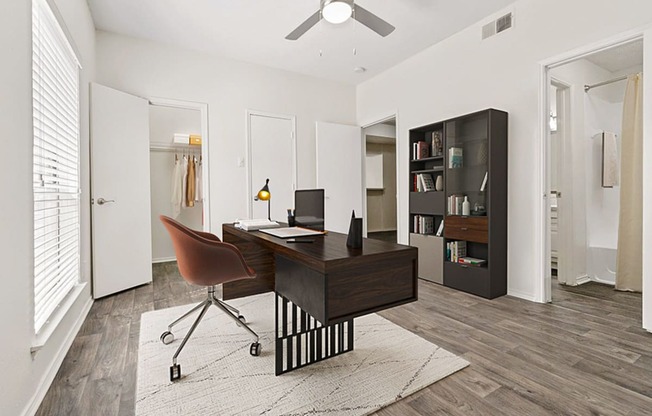 the residence on lamar apartment homes has an office with a desk and a chair