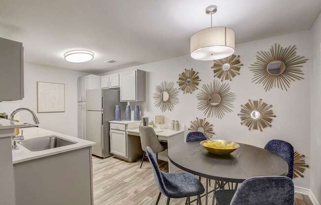 A modern kitchen with a dining table set for four.