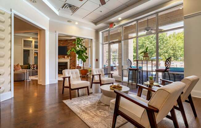 a living room with a fireplace and a table and chairs