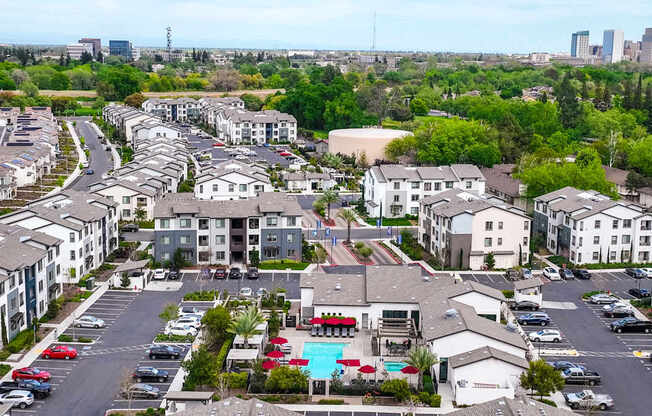 A large apartment complex with a pool in the middle.