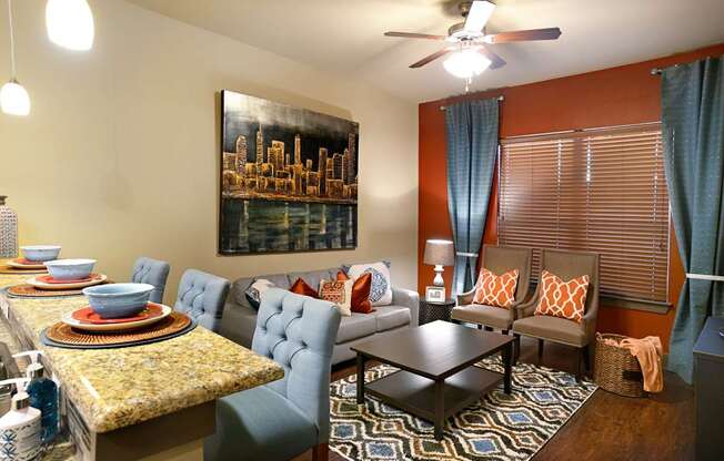 A living room with a dining table and chairs.