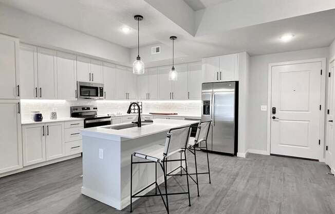Matte black fixtures and hardware, trendy tile backsplashes and wine coolers in kitchen