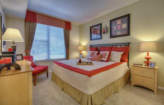 Vue Park West bedroom with wall to wall carpet, queen bed and large windows