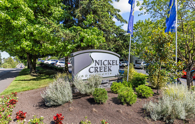 the sign for nick creek park in front of a parking lot