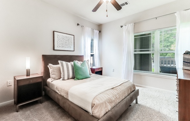 a bedroom with a bed and a ceiling fan at Plantation Crossing, Lafayette, Louisiana