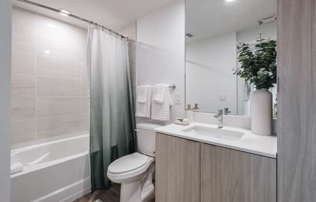 a bathroom with a shower toilet and sink at Altis Santa Barbara, Naples, 34104