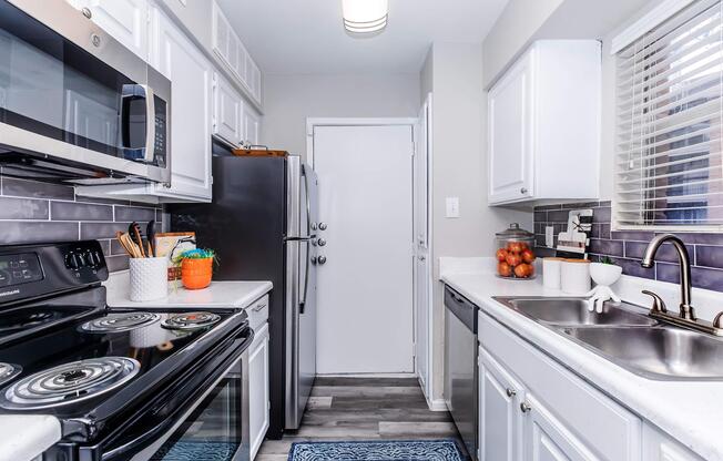 a kitchen with a stove sink and refrigerator