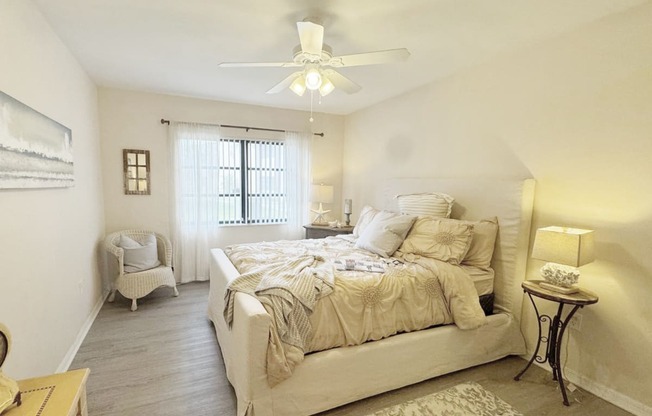 a bedroom with a bed and a ceiling fan