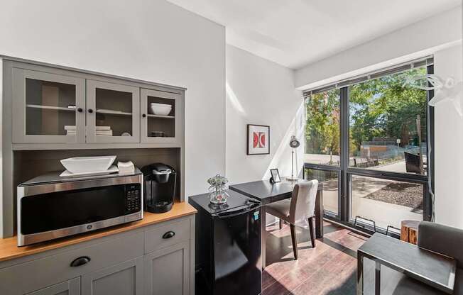 A kitchen with a microwave, oven, and a fridge.