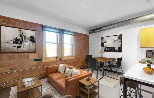 A living room with a brown couch and a coffee table.