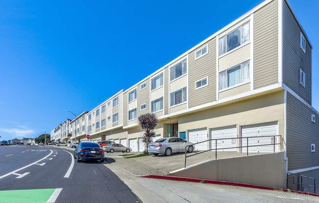 Apartments Near San Francisco State University - Terrace View - Exterior Street View of Apartment Building with Garages.at Terrace View Apartments, Daly City, CA