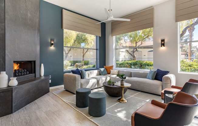 a living room with couches and chairs and a fireplace at Mirasol Apartments, Las Vegas, 89119