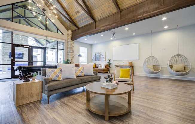 A modern living room with a wooden floor and a glass ceiling.