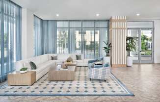 Grand clubhouse with lounge seating area at The Marc Apartments in Palm Beach Gardens FL