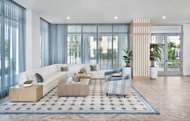 Grand clubhouse with lounge seating area at The Marc Apartments in Palm Beach Gardens FL
