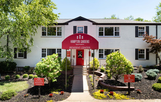 a white building with a red sign in front of it