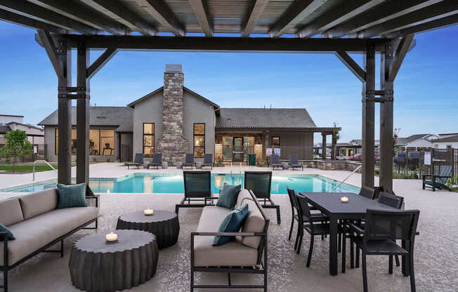 A modern outdoor living space with a pool and furniture.