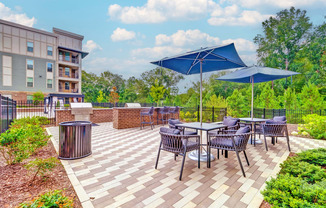 the reserve at bucklin hill patio with tables and umbrellas at Artesia Big Creek, Alpharetta, GA, 30005