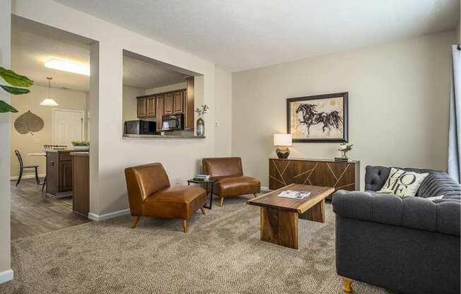 a living room with a couch chairs and a coffee table