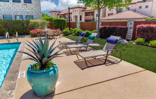 a patio with chairs and a swimming pool