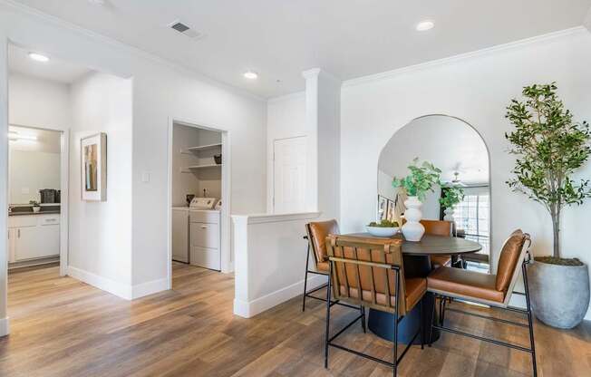 A dining room with a table and chairs.