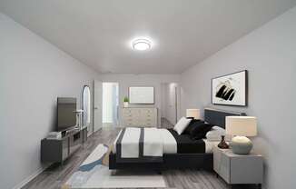 A modern bedroom with a large bed and a television.